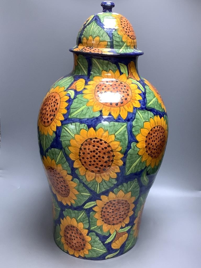 A large Mexican painted terracotta lidded baluster vase, decorated with stylised sunflowers